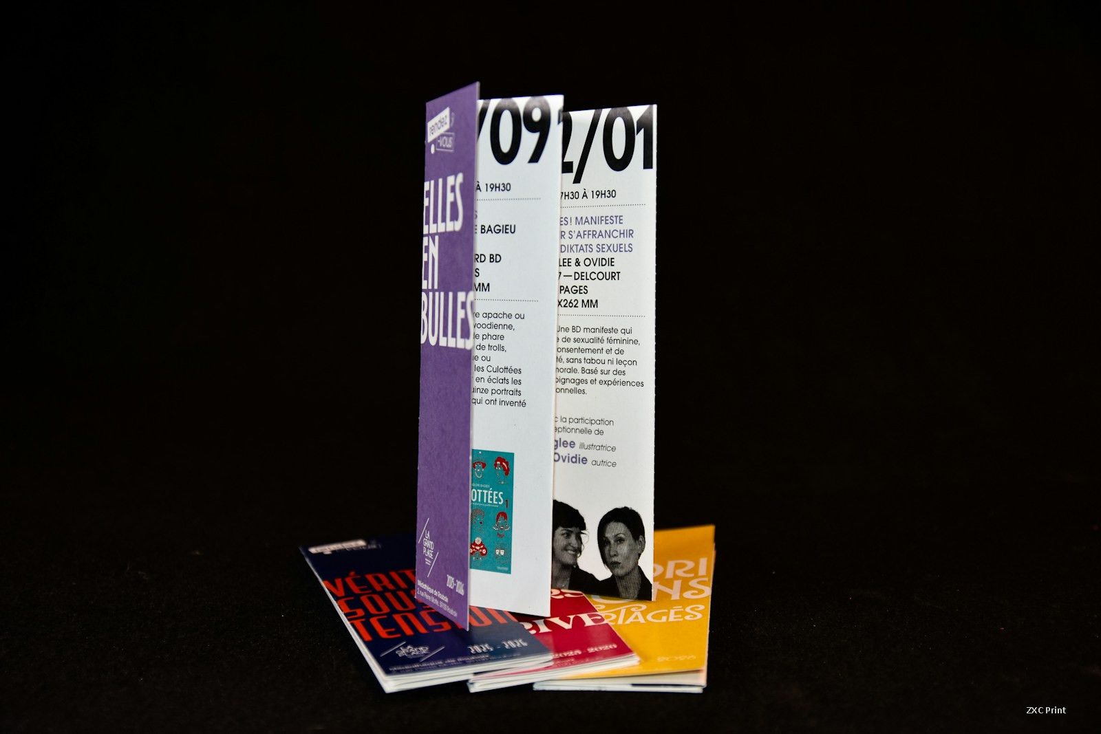 Stack of folded printed brochures with a coated print finish