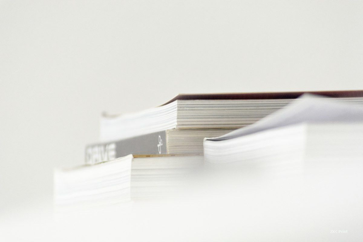 Perfect bound book blocks stacked on a table after the binding line